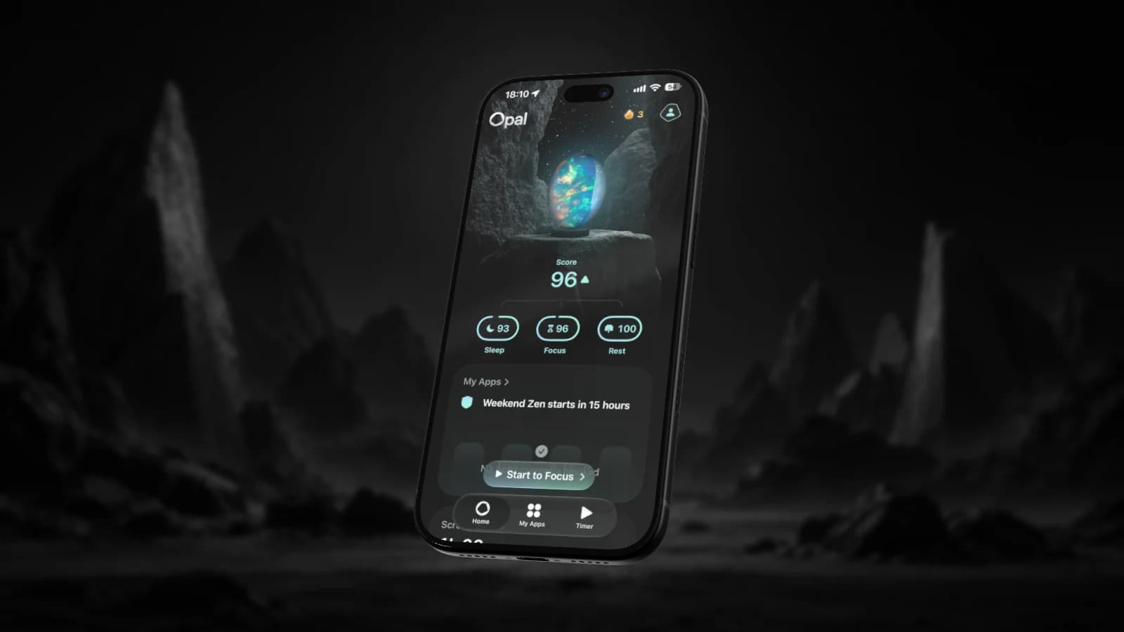 An iPhone displaying Opal, lit against a dark rocky landscape